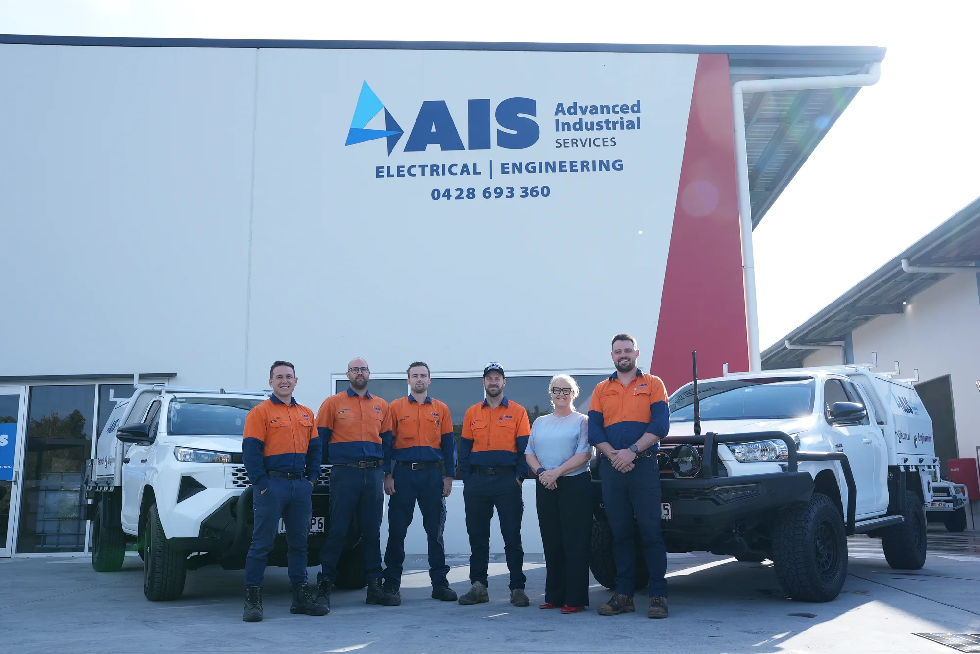 The AIS team outside the Narangba workshop with their service vehicles